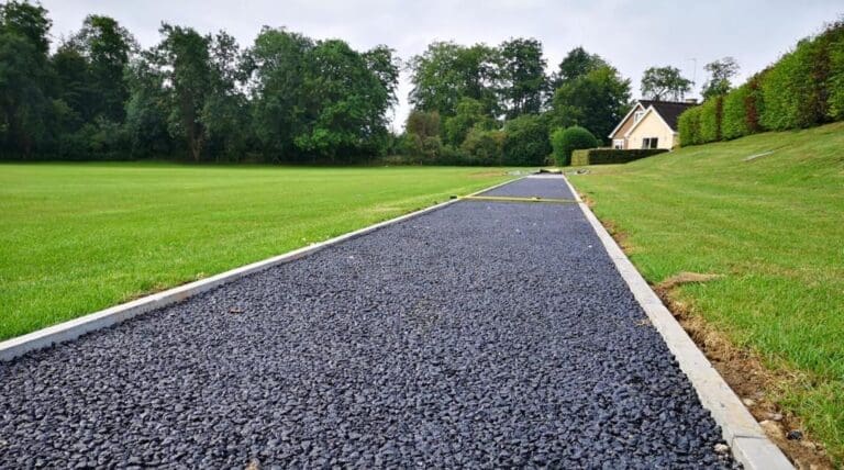 Tarmaced road leading down to a house
