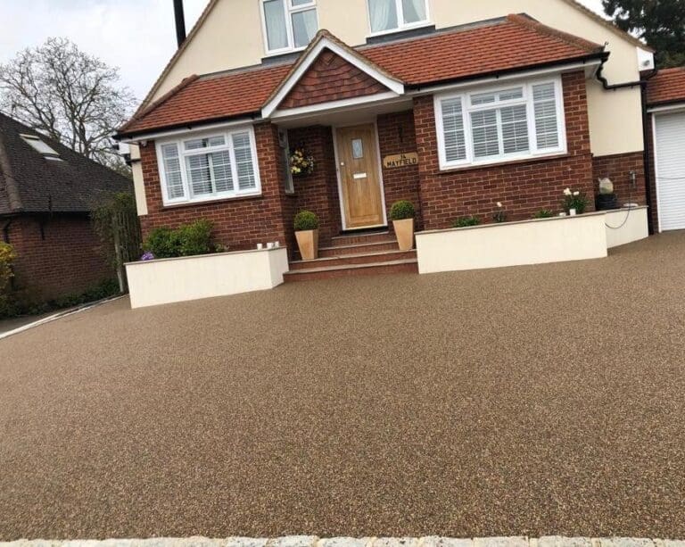 Light brown resin driveway installation for detached house